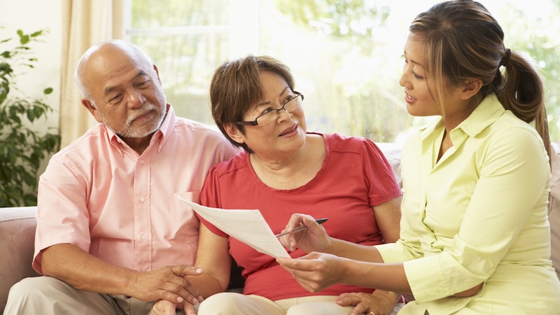 A woman helping a couple plan and avoid probate.