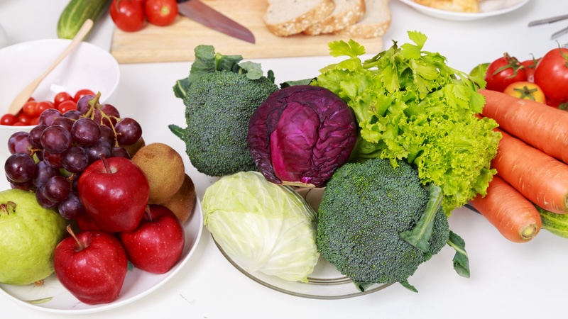 Plates with a colorful variety of fruits and vegetables.