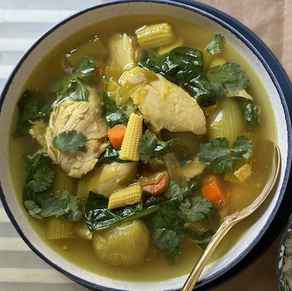 Top view of a bowl of chicken and lemongrass soup.