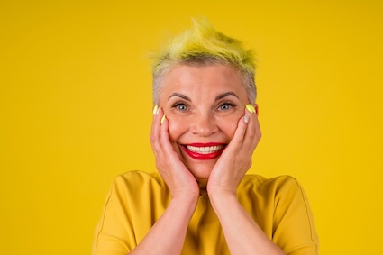 A senior woman manages aging and hair by gladly dying her hair yellow. Image by Nightunter.