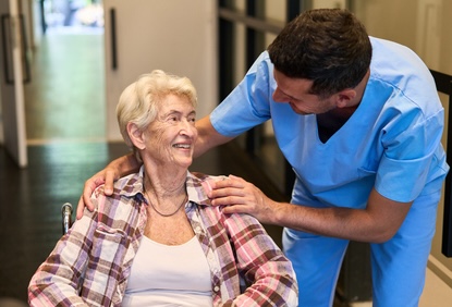 Woman in a care facility with a helpful caregiver. By Robert Kneschke. Article on the growing caregiver shortage 