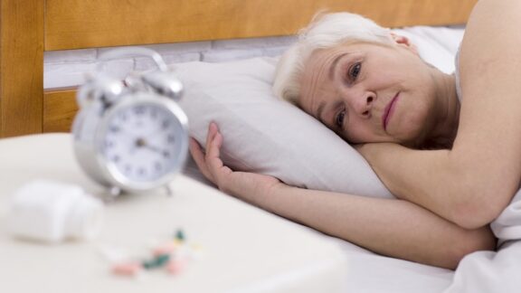 A woman lying awake getting insufficient sleep