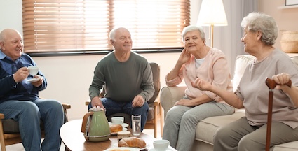 A senior listening to friends' health complaints