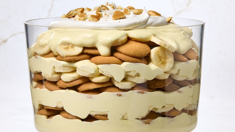 A great big glass of banana pudding with multiple layers of wafers.