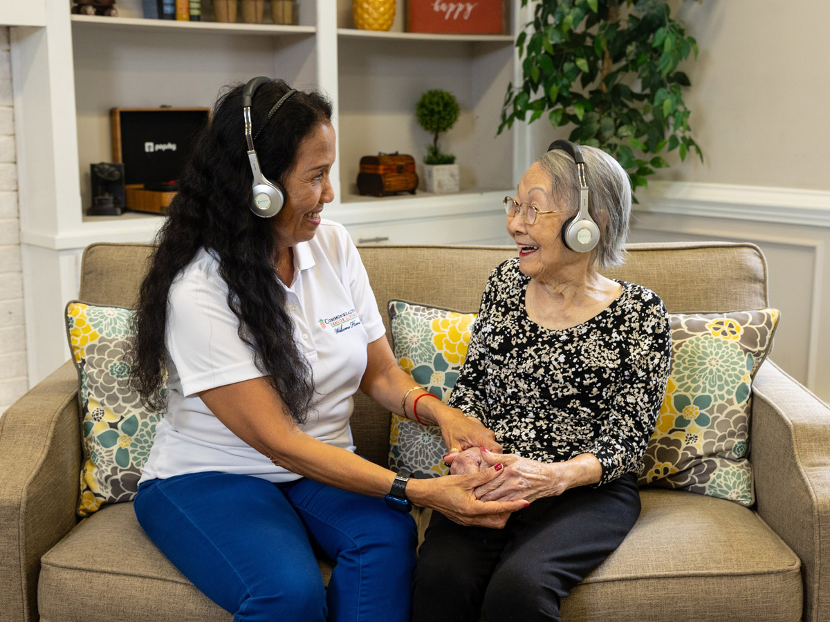 Commonwealth Senior Living at Georgian Manor Lady with Caregiver Listening to Music