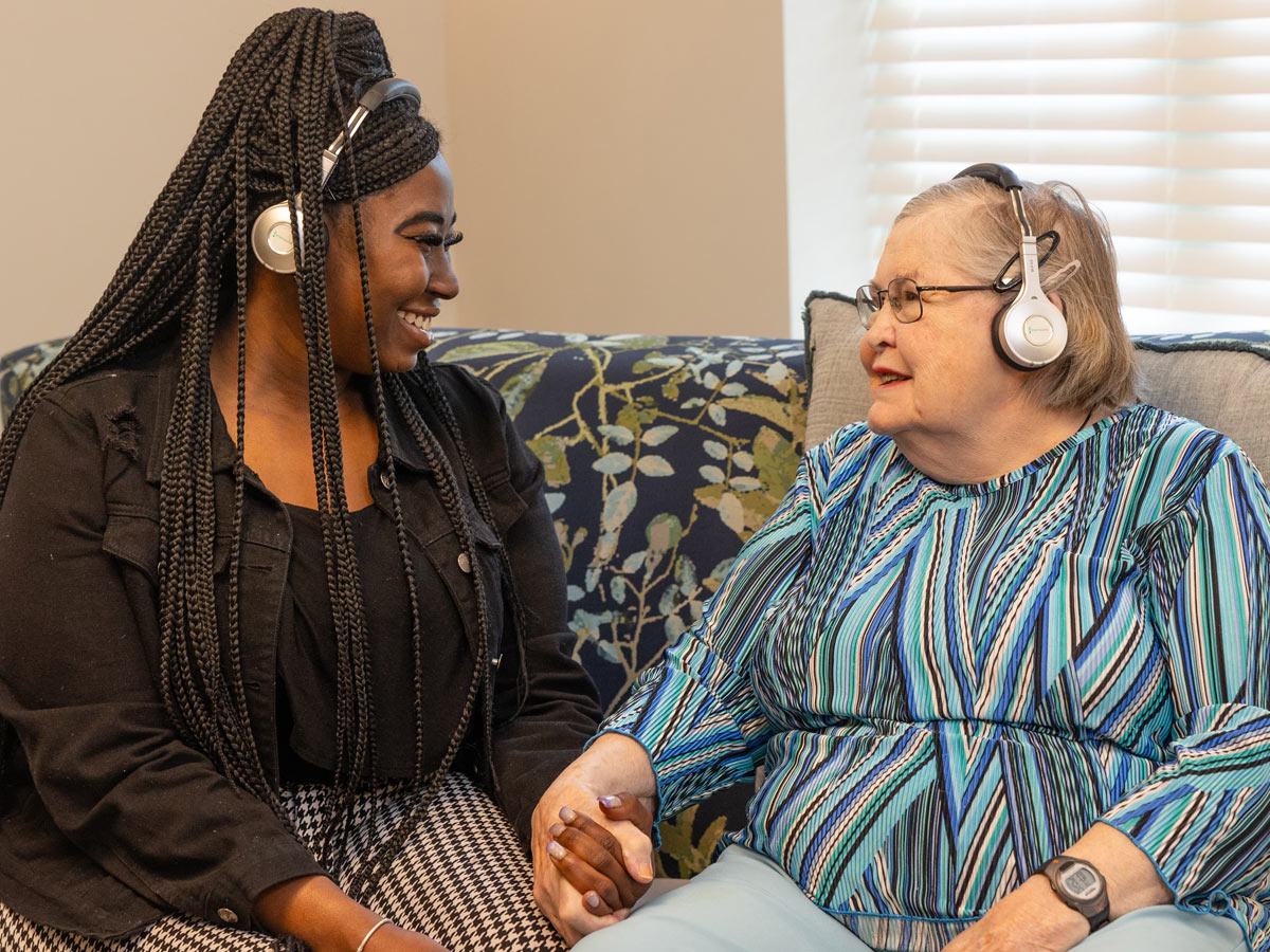 Commonwealth Senior Living at Grand Rapids Lady with Caregiver Listening to Music