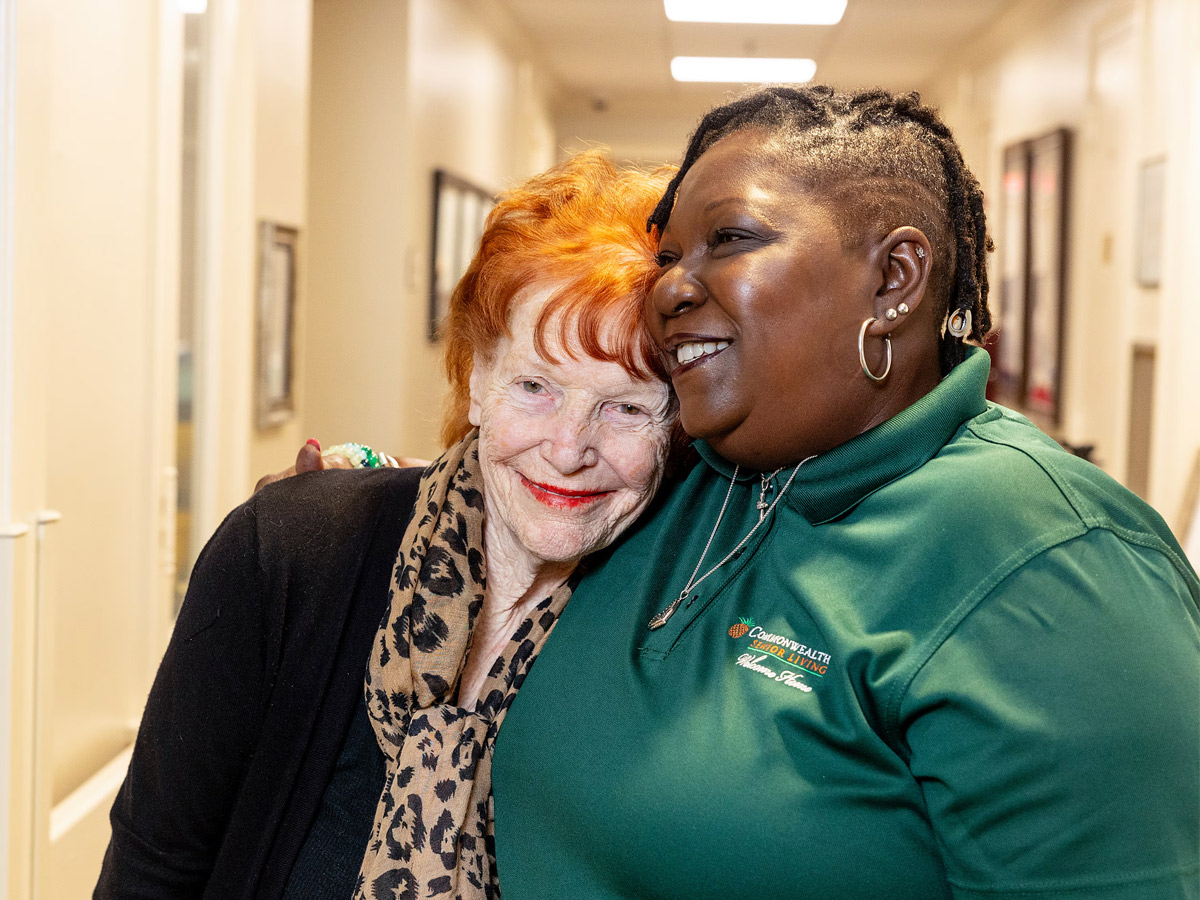 Commonwealth Senior Living at the Ballentine Lady Hugging Caregiver