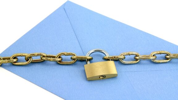 A letter with a chain and lock, the concept of how to avoid mail theft. Image by Feng You