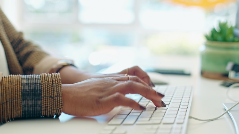 Woman on computer planning Medicare worried about Medicare tax torpedo