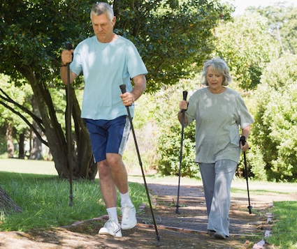 A couple engaged in Nordic walking for seniors. By Wavebreakmedia Ltd.
