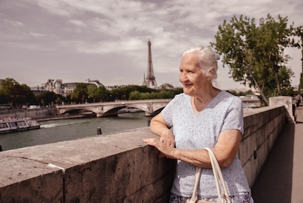 Retired woman in Paris, with the Eiffel Tower in the background. France is one of the best healthcare options for expats from the US. Image by Artanika