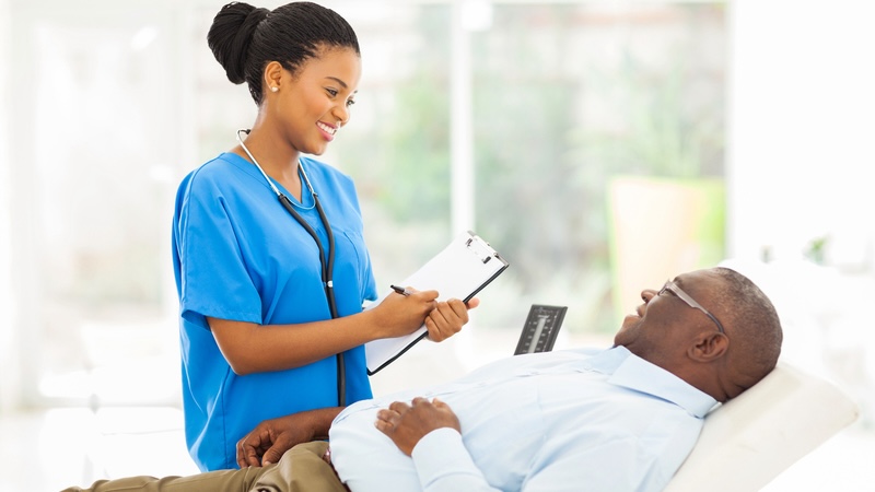 A man talking with his direct primary care doctor.