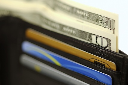 Money sticking out of a wallet.