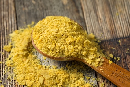 Nutritional yeast in a big wooden spoon.