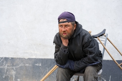 disabled older man on a city street shows the issue of senior homelessness. By wrangler