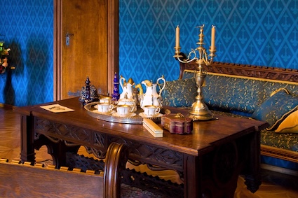 Heirlooms like a table and tea wares in an old room.