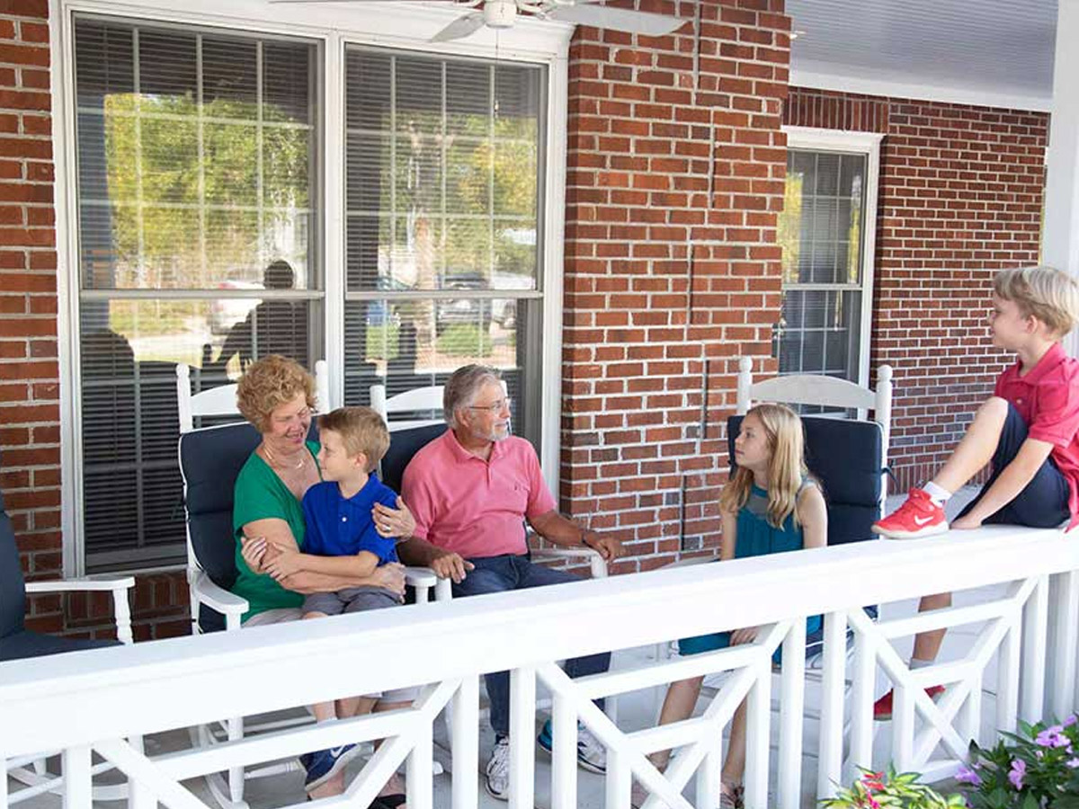 Kempton of Brightmore Grandparents Sitting on Balcony with Grandkids