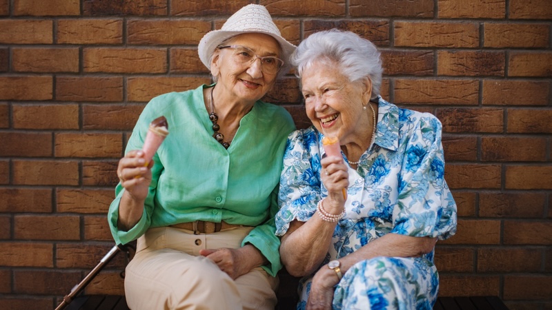 The chance to make new friends, like these two senior women, is among the advantages of semi-private living in memory care