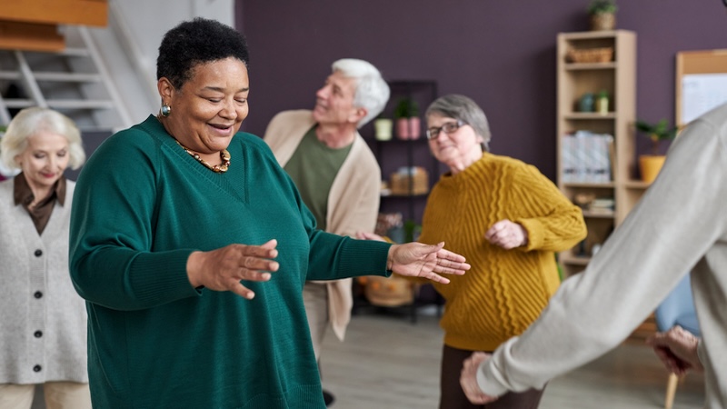 Residents dancing in a planned activity, making Social Connections in a Retirement Community