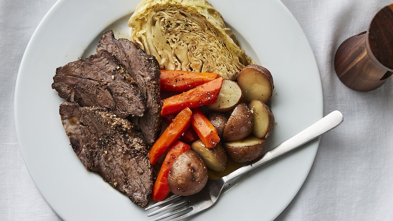 Corned beef & cabbage ready to eat on a plate.
