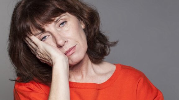 Tired woman has perhaps learned caregiving lessons. Studio Grand Web