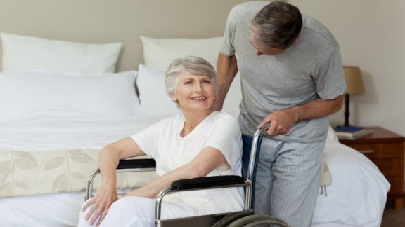 A man who is dealing with caregiver stress with his wife in a wheelchair