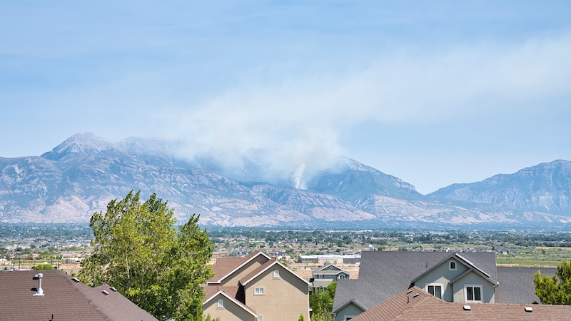 A wildfire in a distant mountain symbolizing wildfires and health risks.