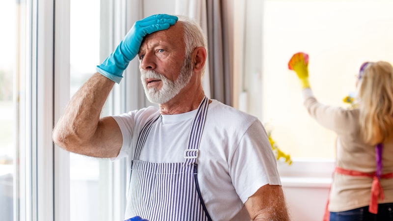 A man unhappy doing chores and experiencing marital stress over chores.