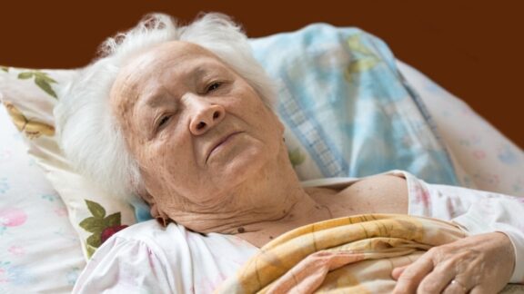 An elderly woman in bed.