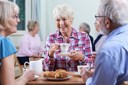 Three friends in a senior living community having breakfast together. Ian Allenden