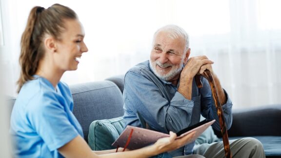 Quality staff can help ease the transition to memory care, as with this nurse interacting with the resident. Picsfive
