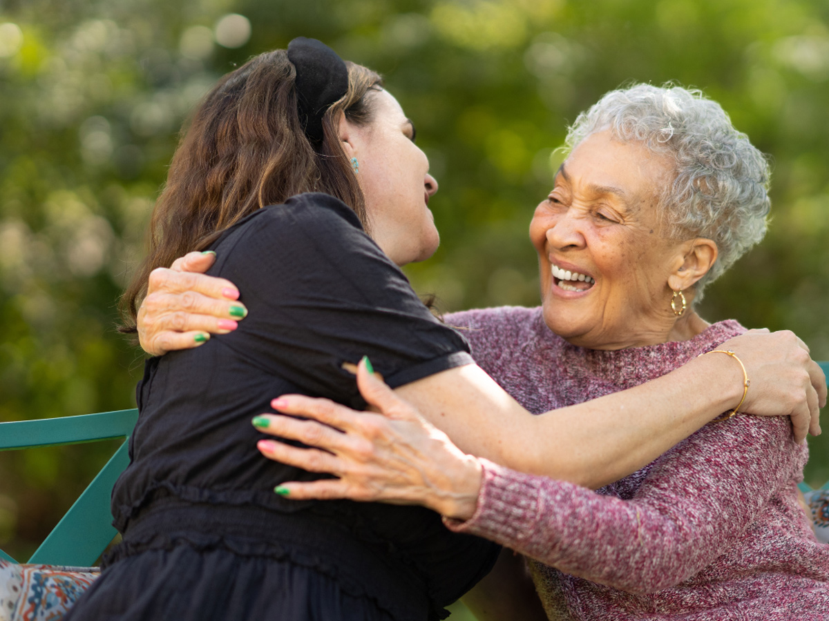 Naborforce Senior Lady Hugging Friend