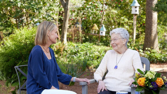 Naborforce Senior Lady with Friend Sitting Outside