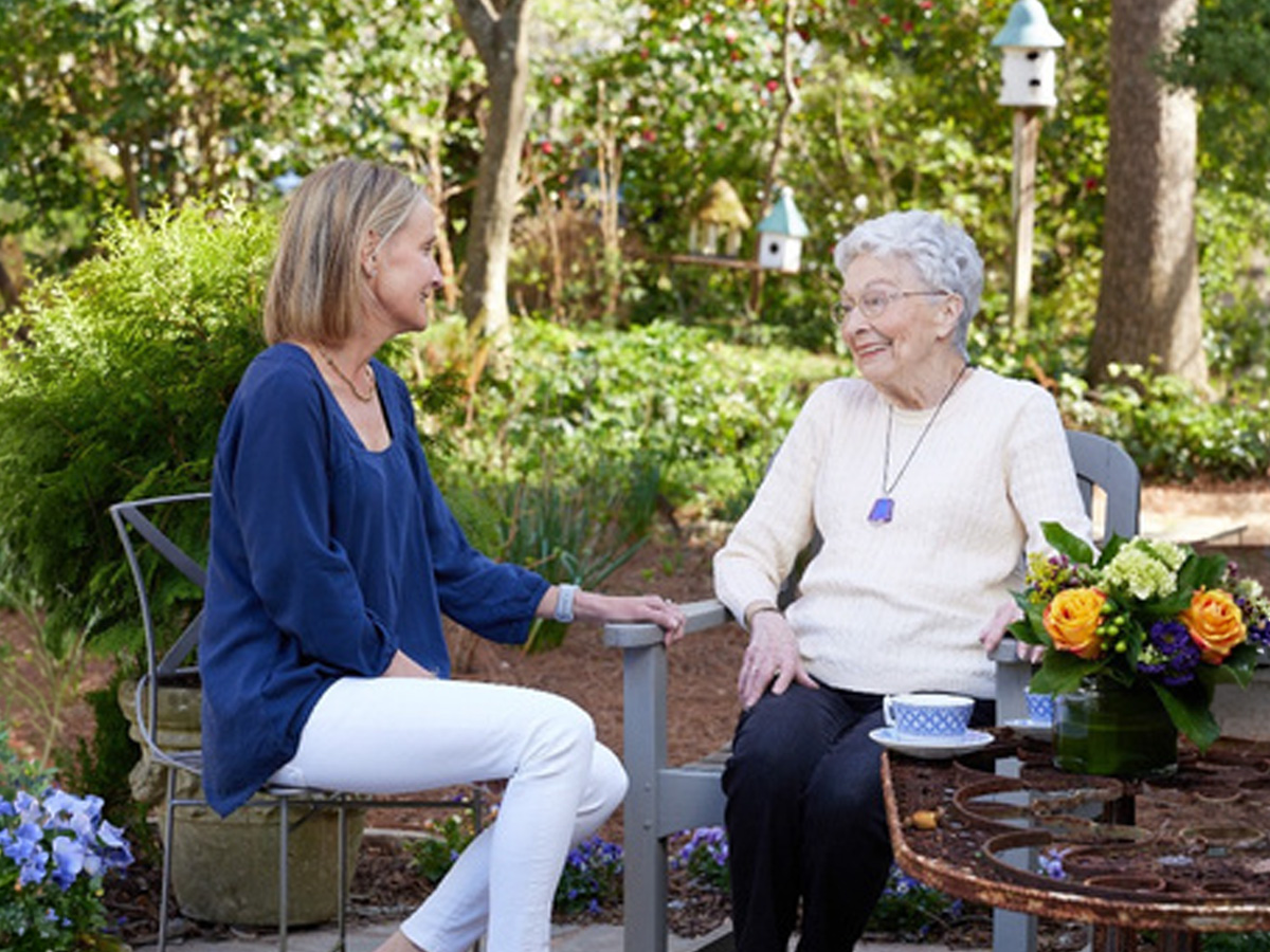Naborforce Senior Lady with Friend Sitting Outside