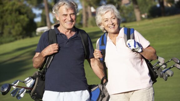 Seniors golfers - a man and a woman - on a golf course