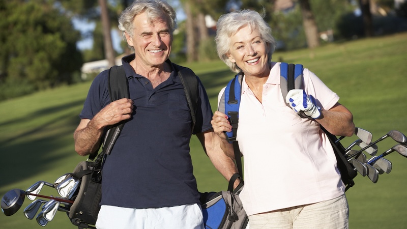Seniors golfers - a man and a woman - on a golf course