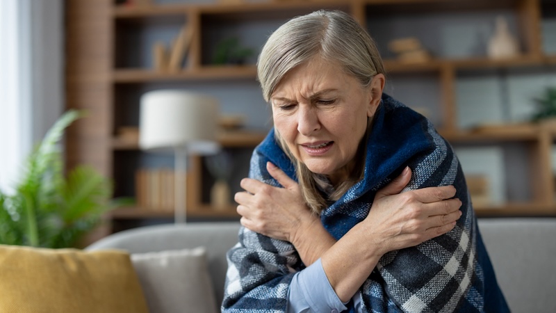 A woman shivering in a blanket always cold