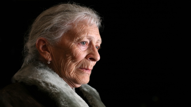 a mother is depressed in front of a black background
