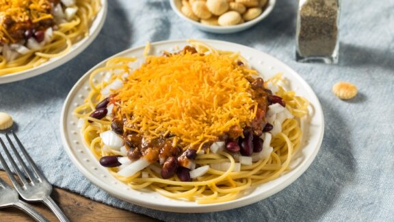 Homemade Cincinnati Chili Spaghetti with Cheese and Onion, one of seven iconic Ohio foods.