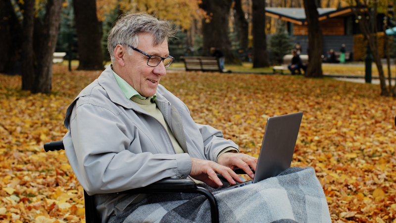 An independent wheelchair user on his computer