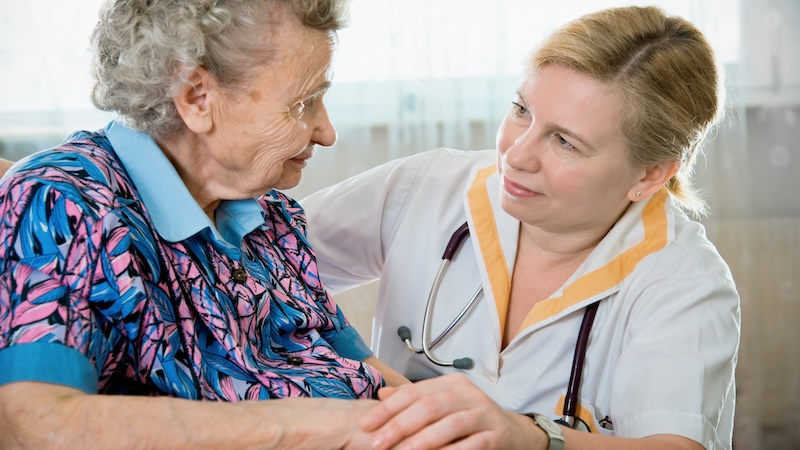 A woman with a nurse. For article on how to protect assets when using Medicaid