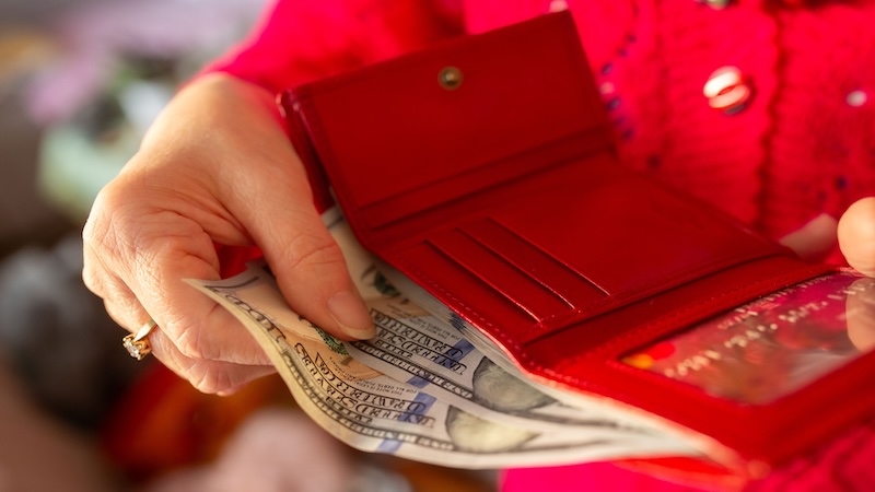 A woman in red giving up a bunch of money because she made the biggest mistake
