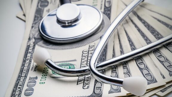 Cash money and a stethoscope representing Medicare surcharges