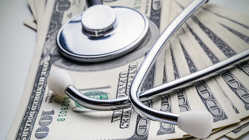 Cash money and a stethoscope representing Medicare surcharges