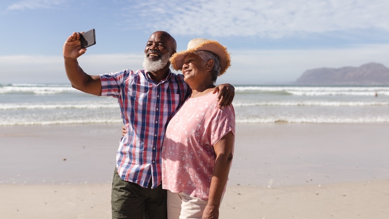 couple on beach for senior travel. Wavebreakmedia Ltd