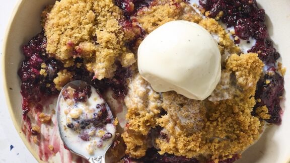 blackberry crumble with ice cream on top.