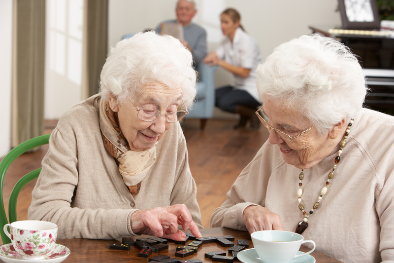Two women playing dominos at their senior living in Maryland