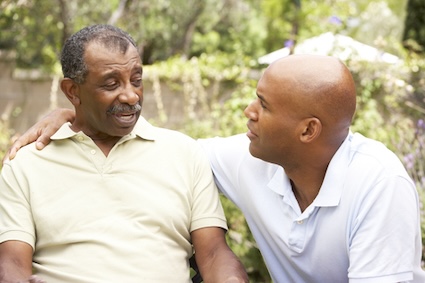 A senior man and son having a discussion after learning that issues with finances can be a sign of dementia