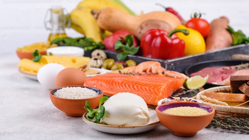 A variety of healthy foods, like eggs, peppers, and salmon, for people conscious of food quality.