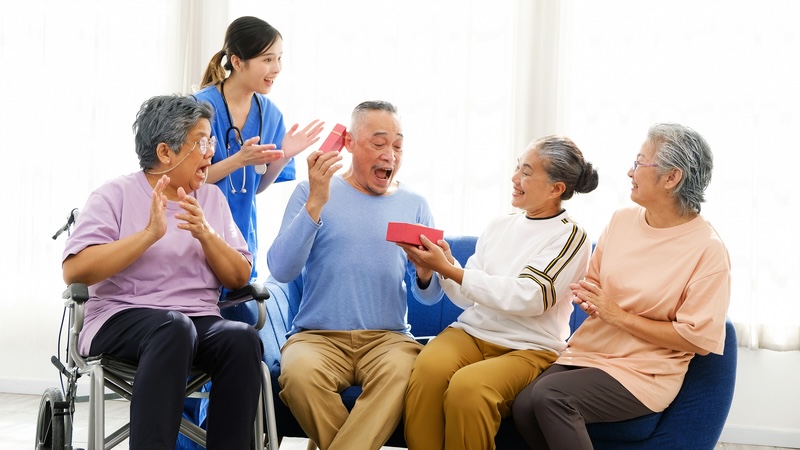 Group of seniors at a community. The bright light from windows is part of designing a physical environment for seniors